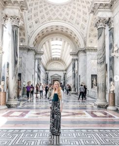 Rowan Murray standing in a museum grand hall in Italy.