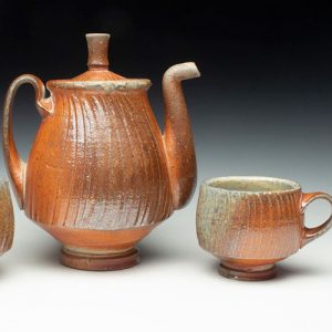 orange ceramic coffee pot and coffee cup