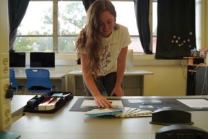 student working on her project in the graphic design computer lab