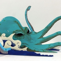 Wood cut sculpture of a blue octopus.