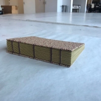 Photo of book without a spine resting on a table.