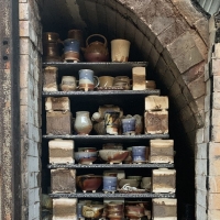 Photo of some ceramic pieces inside of a kiln.